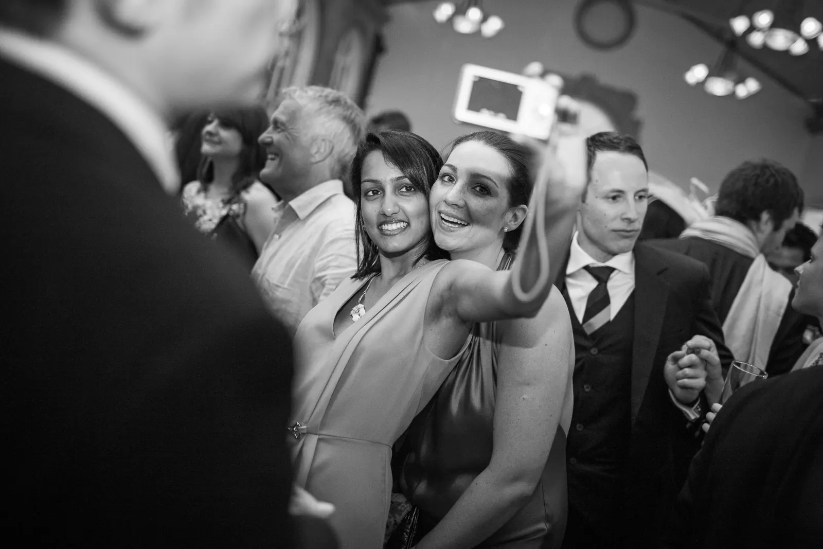 A couple at a wedding taking a relaxed selfie to remember the moment