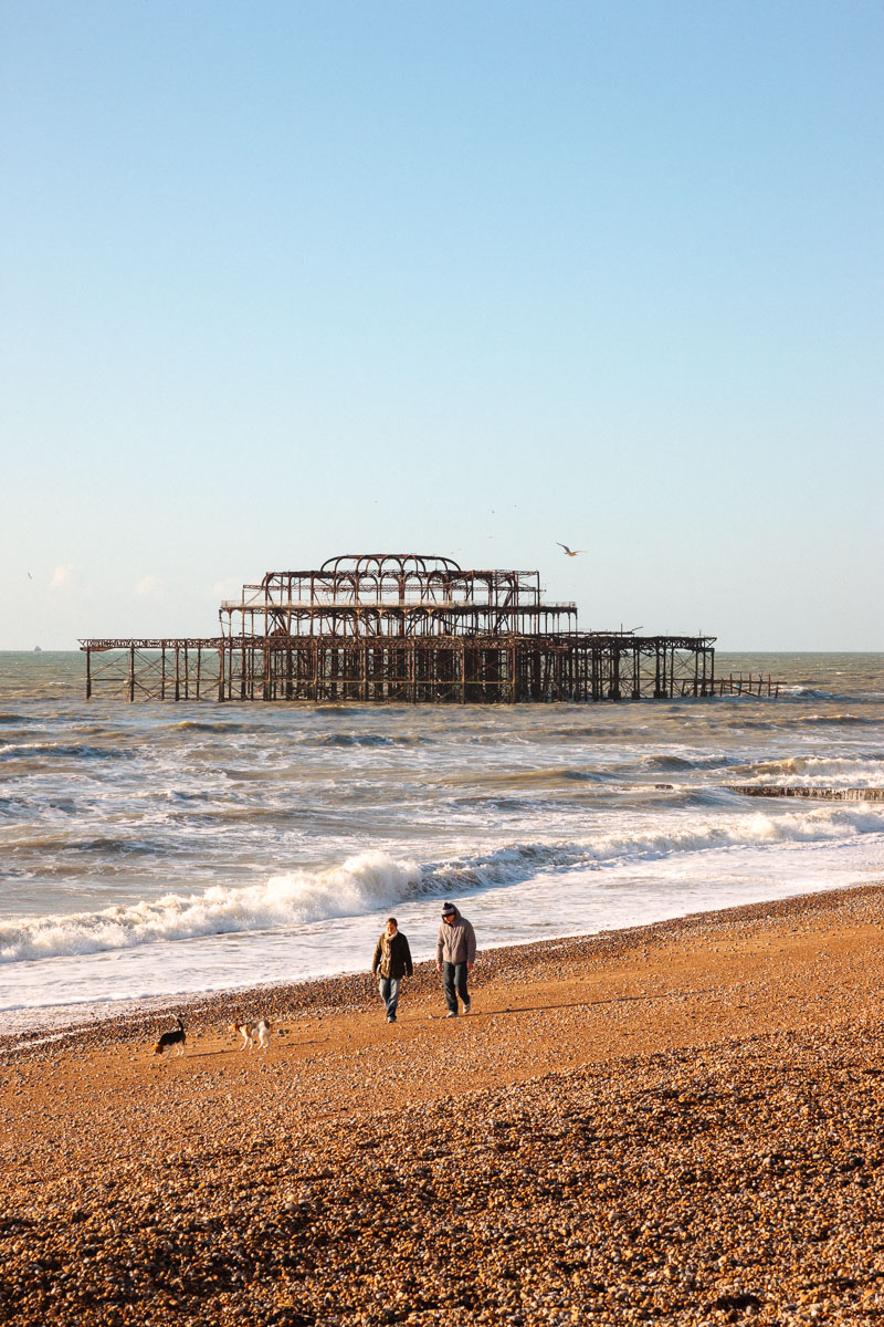 Remains of Brighton West Pier: twisted iron frame in the sea, silhouetted against a blue sky after the 2003 fires