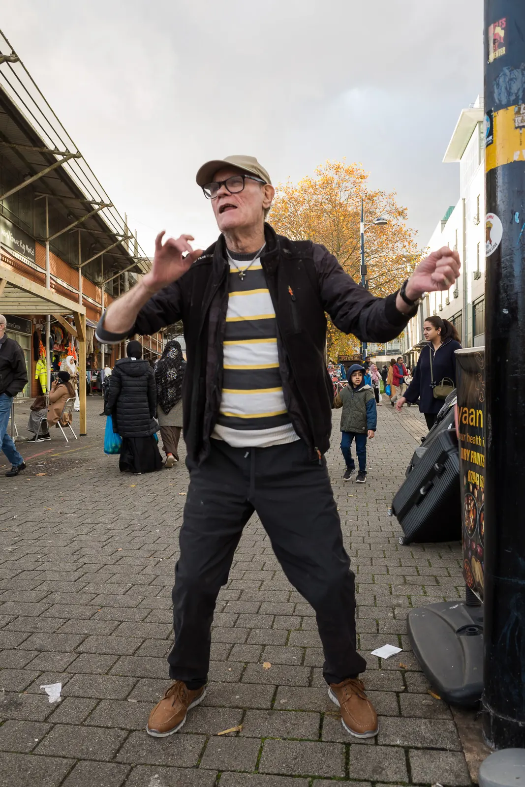 A lone performer amuses passers-by the Bullring Open Market, Birmingham