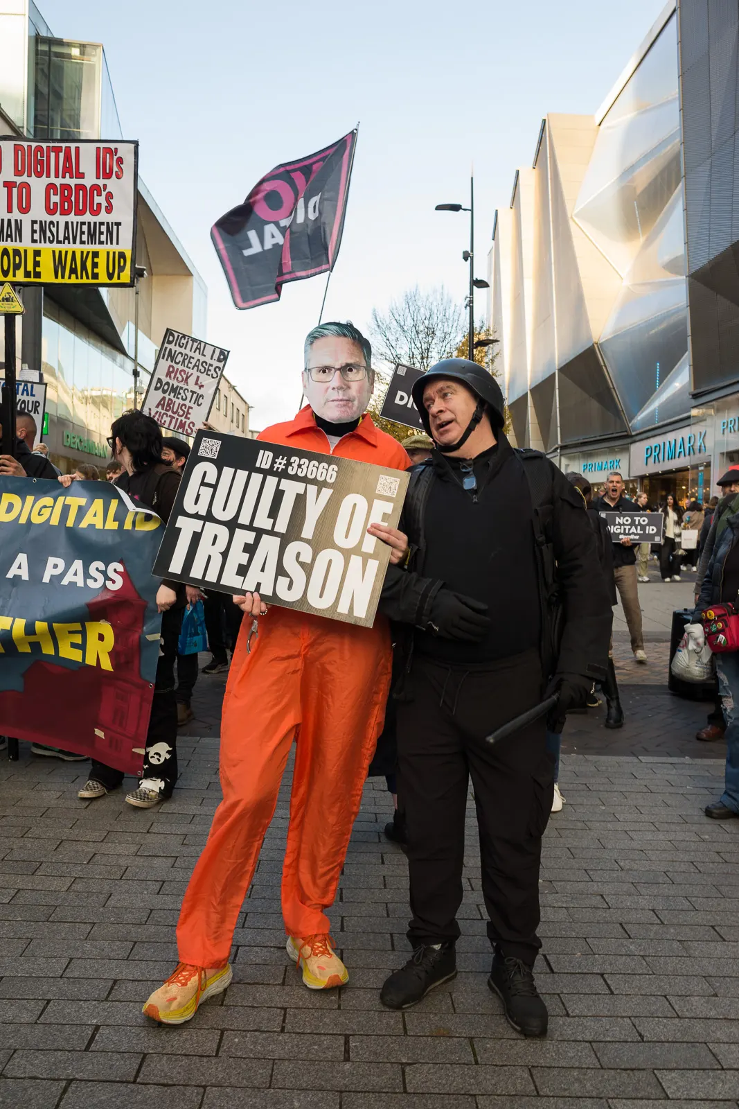 A protestor wearing a Keir Starmer mask and an orange jumpsuit