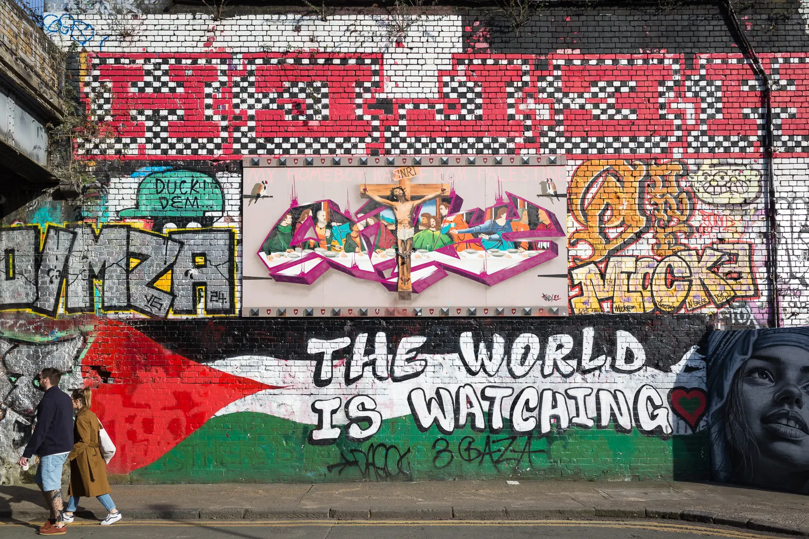 A mural reworking The Last Supper, painted over the colours of the Palestinian flag