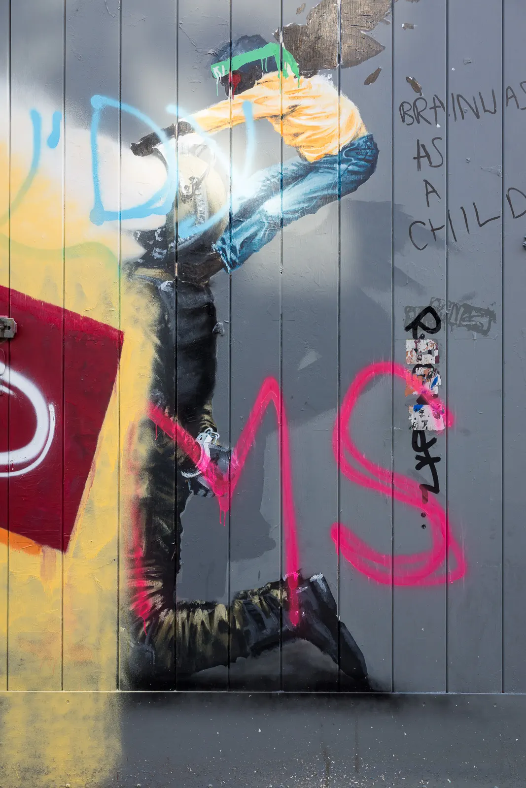 A damaged mural by Palestinian artist Taqi Spateen