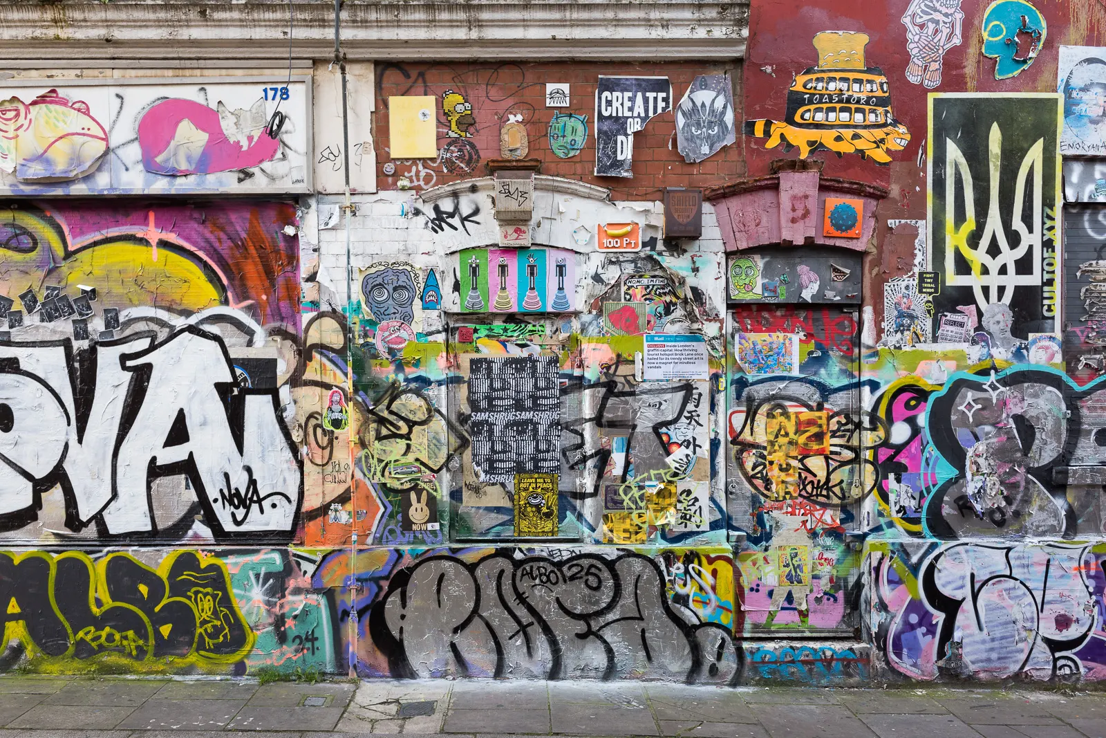 Doors and windows covered in layers of graffiti and street art