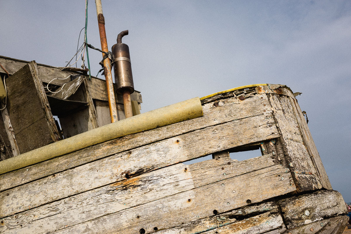 Close-up of a rotting wooden fishing boat on Hastings Beach