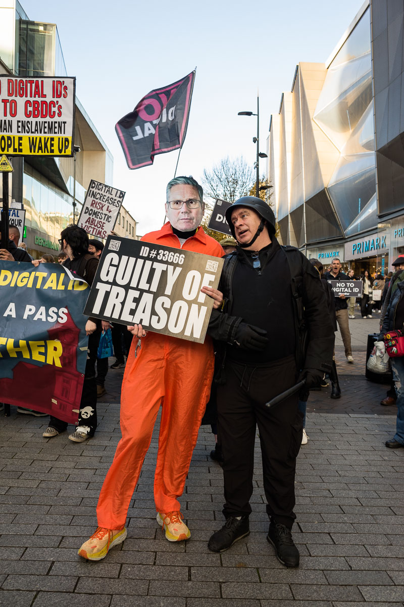 A protestor wearing a Keir Starmer mask and an orange jumpsuit