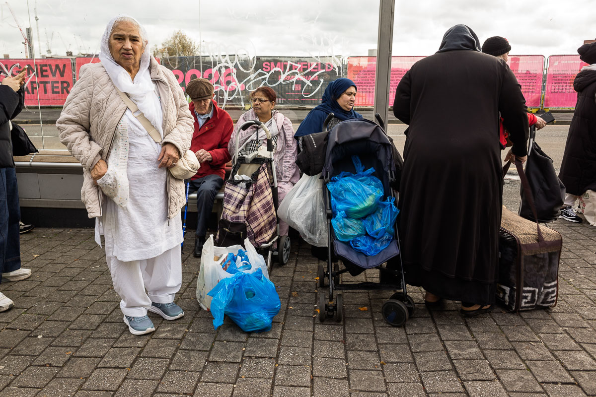 Shoppers rest at a bus stop outside Birmingham's Bullring Open Market
