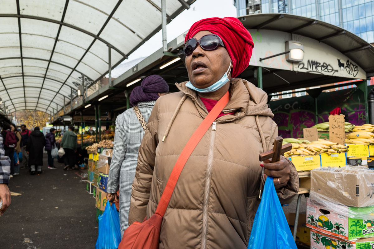A woman shops while holding a small crucifix