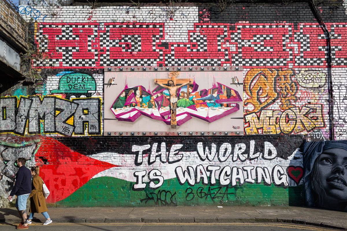 A mural reworking The Last Supper, painted over the colours of the Palestinian flag
