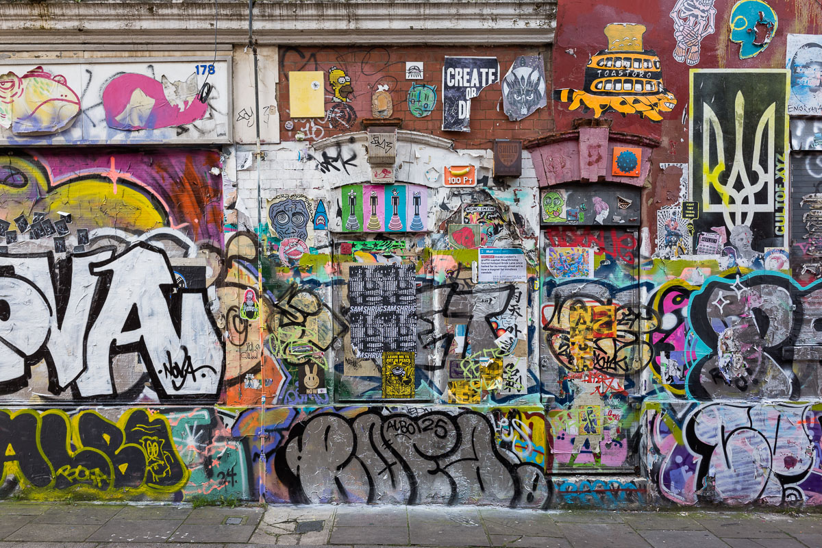 Doors and windows covered with graffiti and street art on Brick Lane's walls