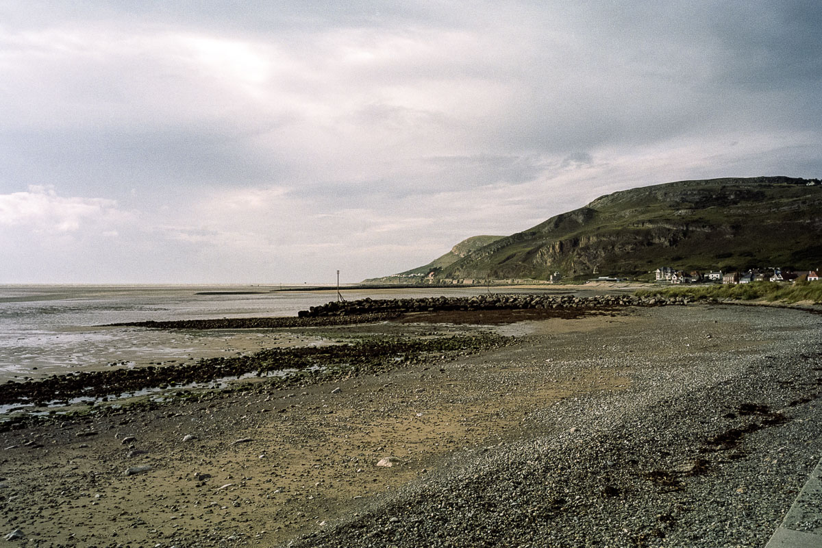 The pebbly West Shore beach stretches toward the Great Orme