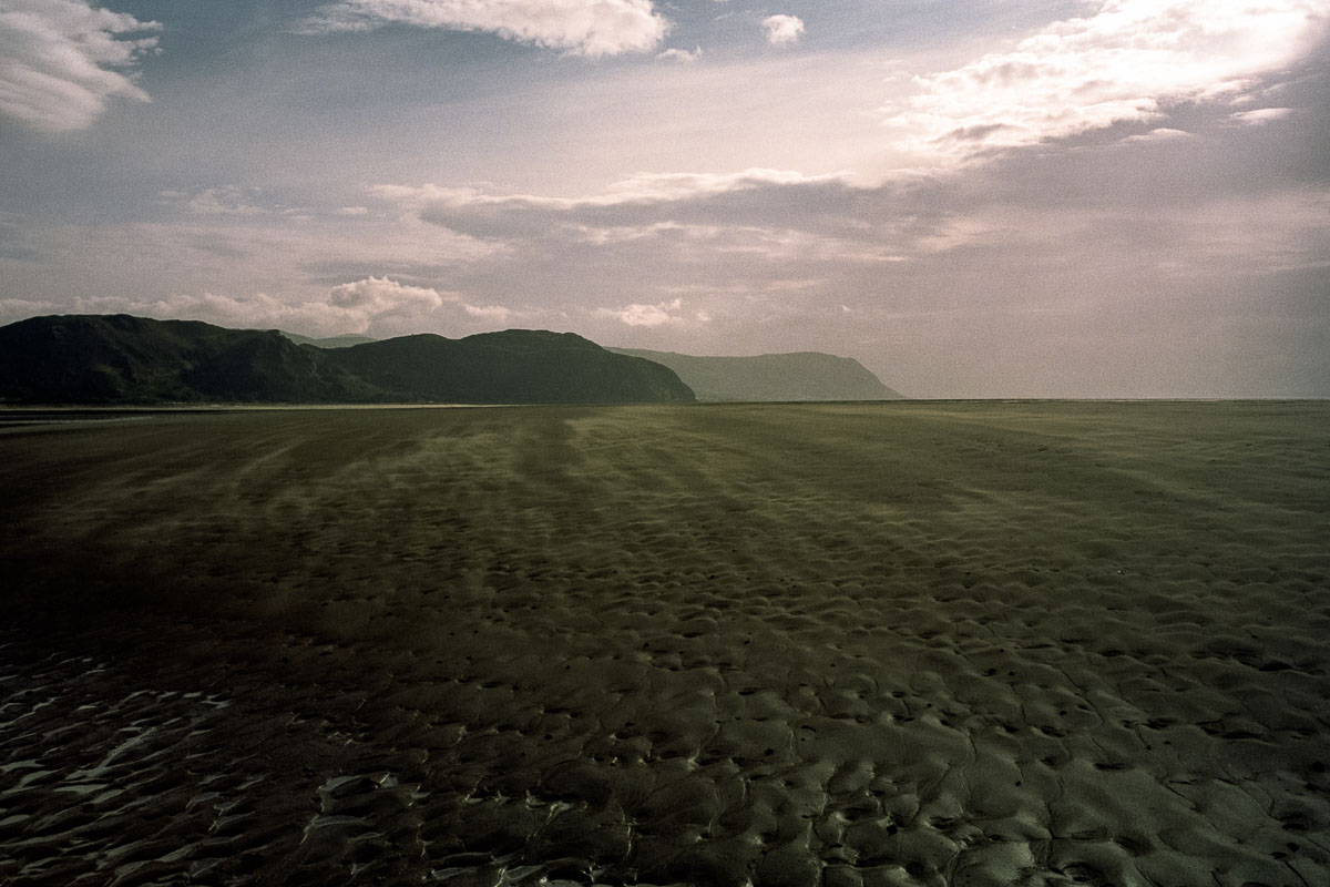 Shifting light, wind, and sand along Llandudno (West Shore) Beach, captured on 35mm film