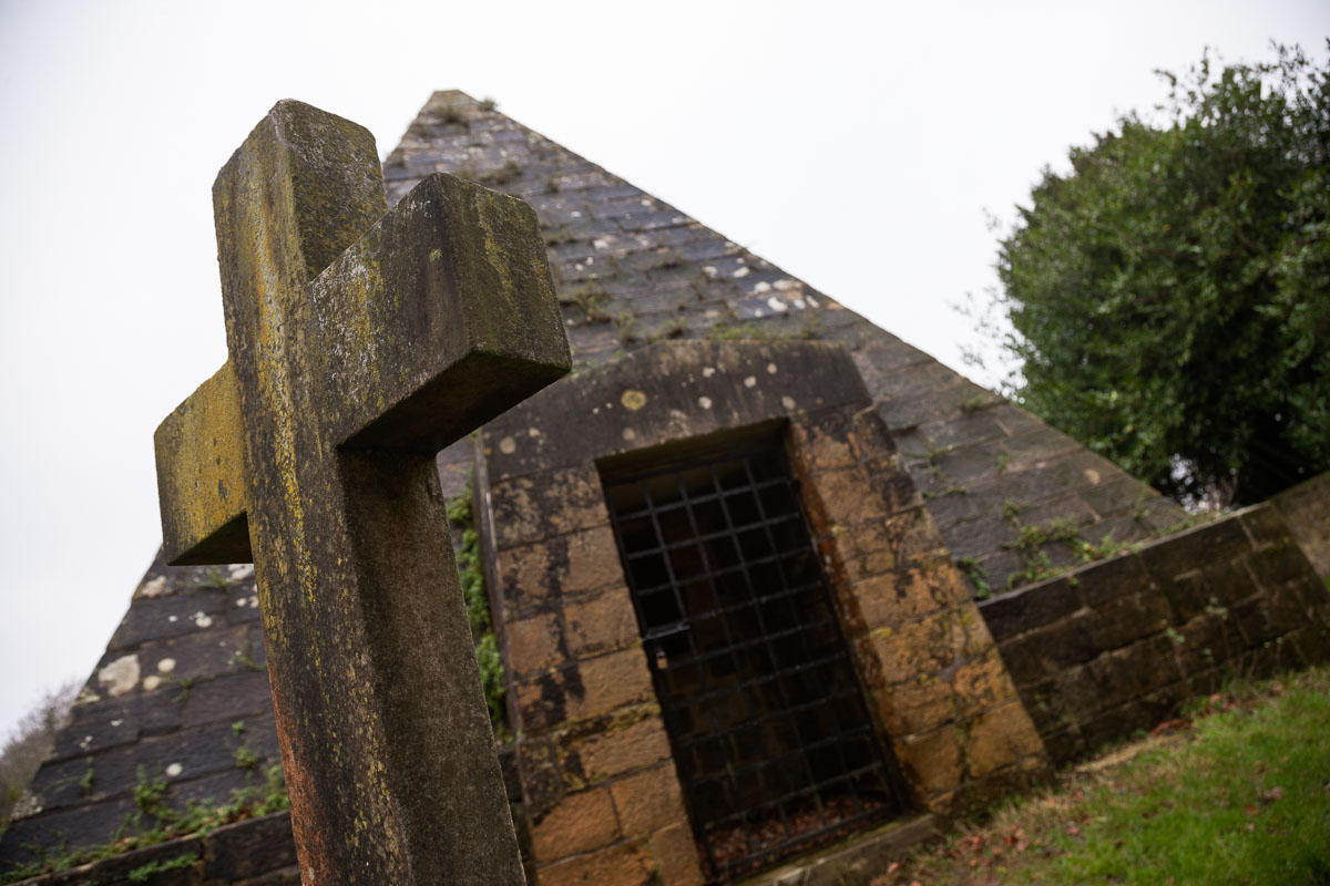 Front view of Mad Jack Fuller’s pyramid tomb in Brightling churchyard, showing its gated entrance and stone façade