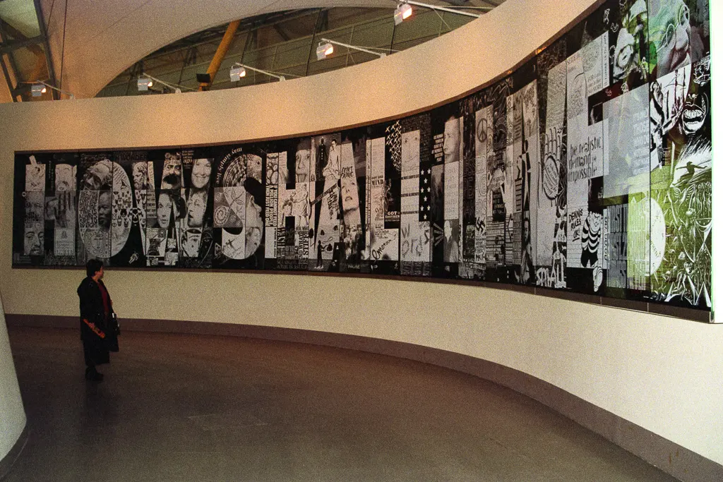 A woman reads the "How Shall I Live?" display in the Faith Zone
