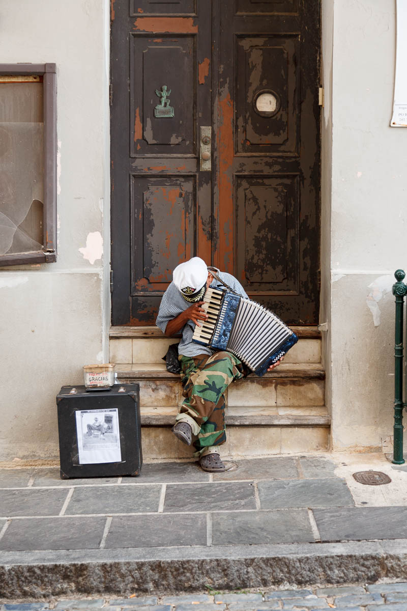 An accordionist playing outside an old building in Old San Juan